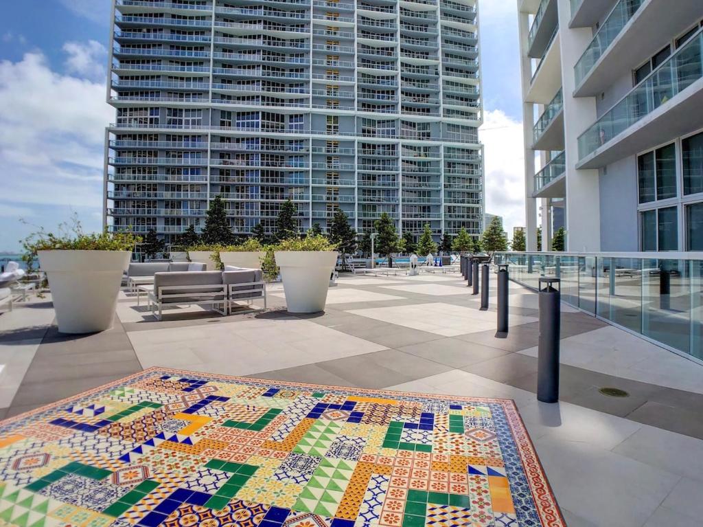 a quilt on a table in front of a building at Sky High Penthouse Corner 2BR 2BA Icon Brickell in Miami