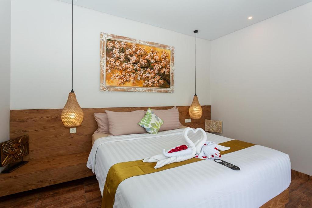 Postel nebo postele na pokoji v ubytování Graha Shanti Guest House