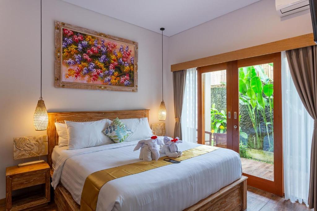 Postel nebo postele na pokoji v ubytování Graha Shanti Guest House