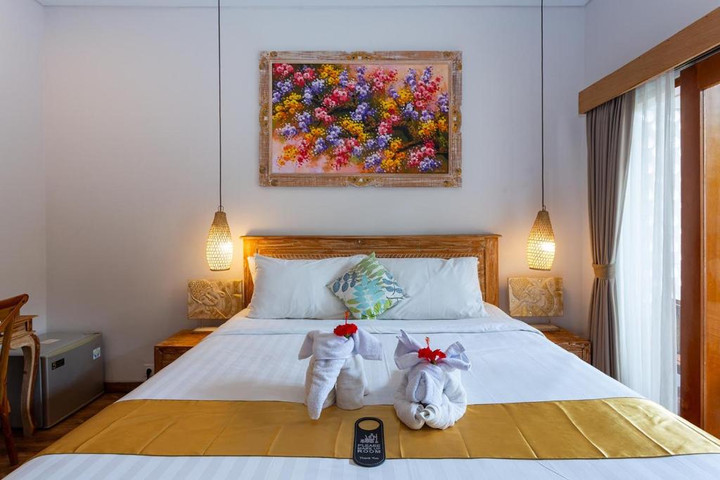 Postel nebo postele na pokoji v ubytování Graha Shanti Guest House