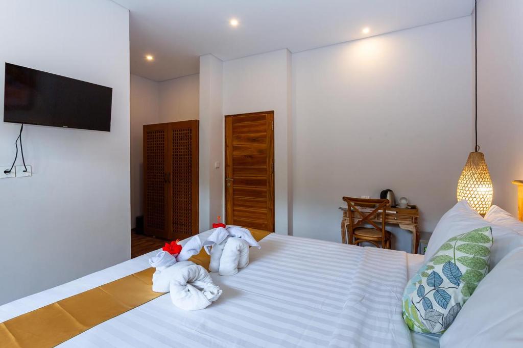 Postel nebo postele na pokoji v ubytování Graha Shanti Guest House