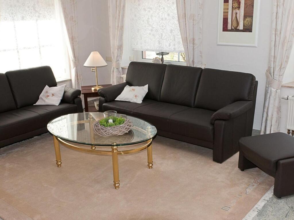 a living room with a couch and a coffee table at Casa Schalkenmehren Grande in Schalkenmehren