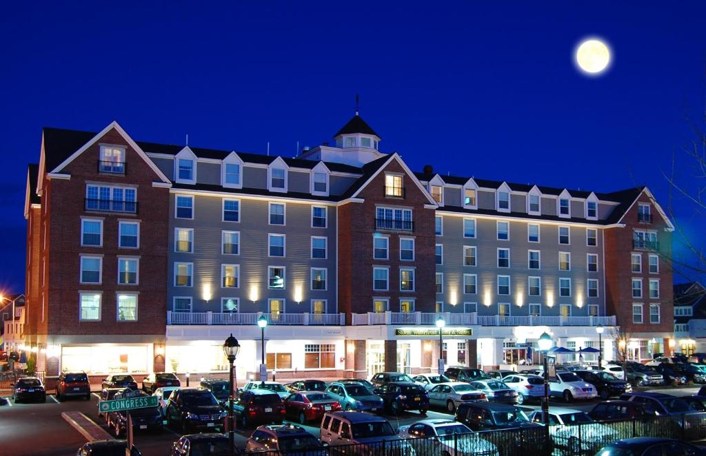 a large building with cars parked in a parking lot at Salem Waterfront Hotel & Suites in Salem