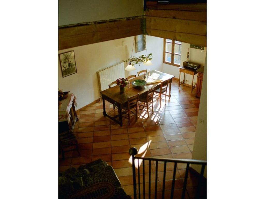 a kitchen and dining room with a table and chairs at Holiday home Mirabel Sous les roches in Mirabel