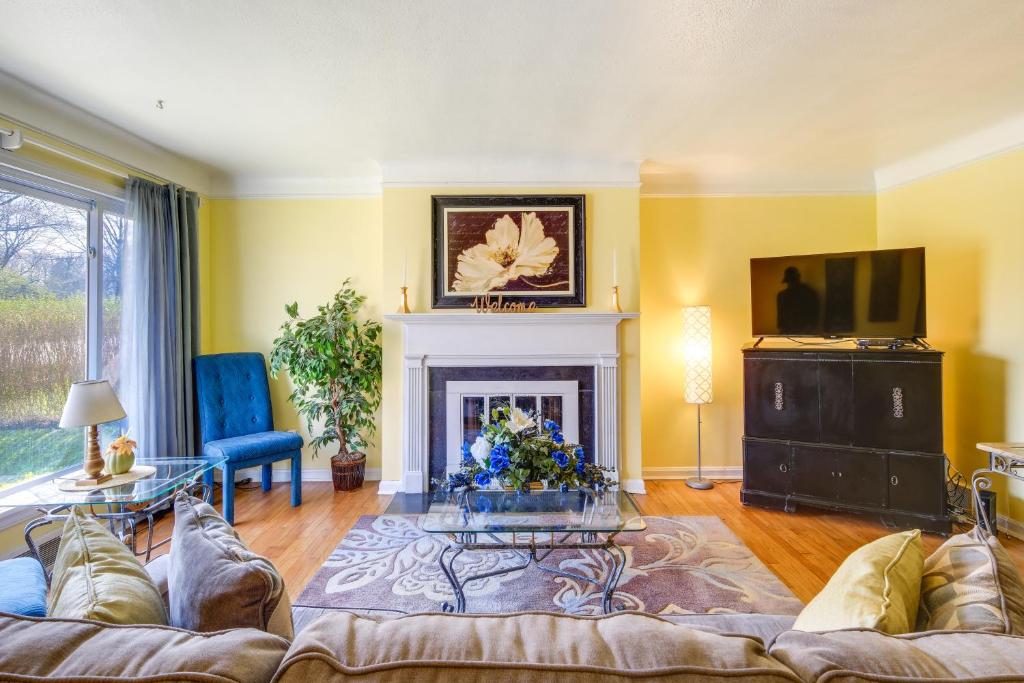 a living room with a couch and a fireplace at Cleveland Heights Home with Sunroom Park Across St! in Cleveland Heights