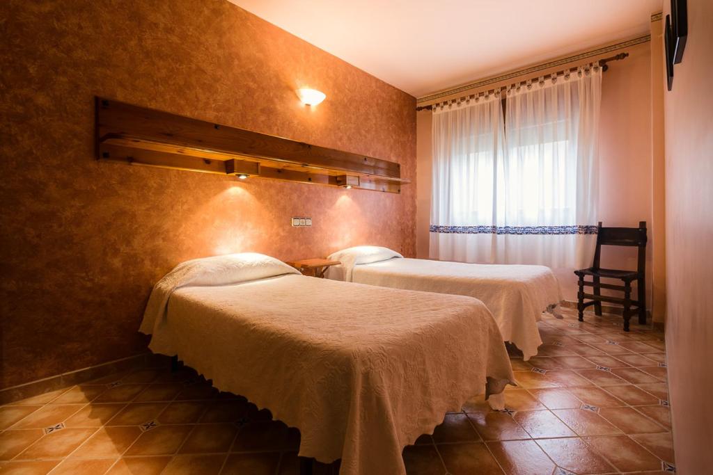 Postel nebo postele na pokoji v ubytování Hostal ROMI