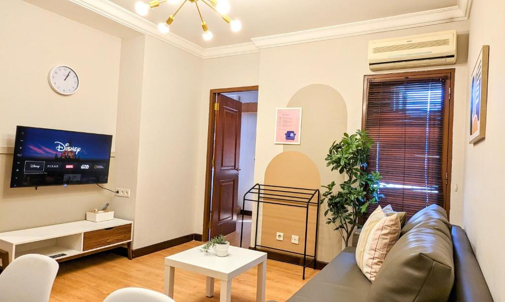 a living room with a couch and a tv at Cottonwood Japandi Apartment at Majesty 509 in Bandung