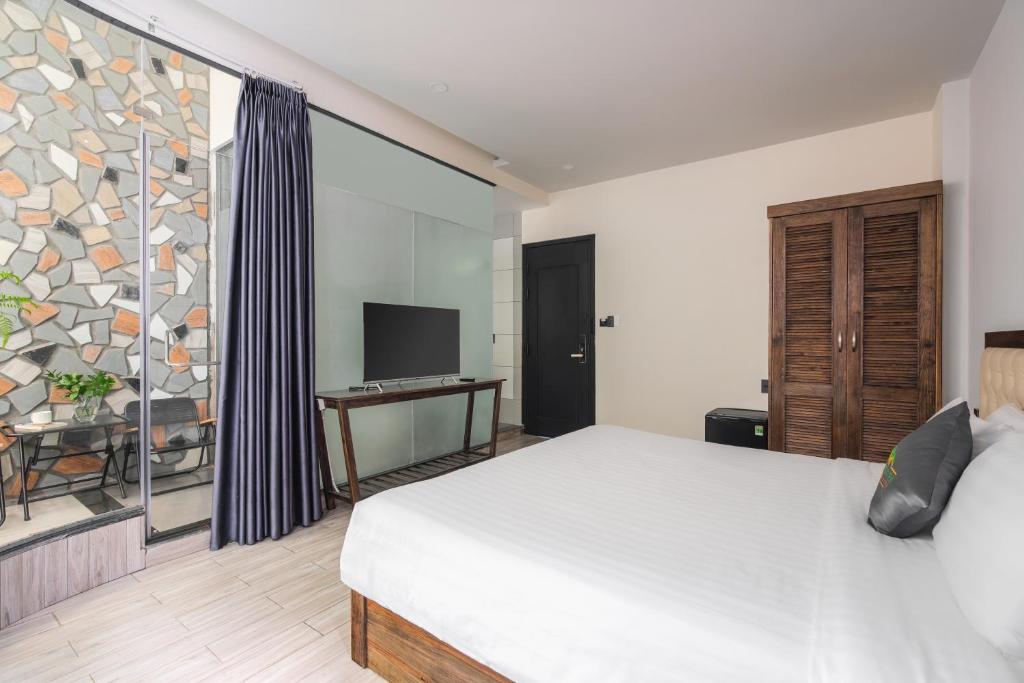TV a/nebo společenská místnost v ubytování Greenview City Hotel