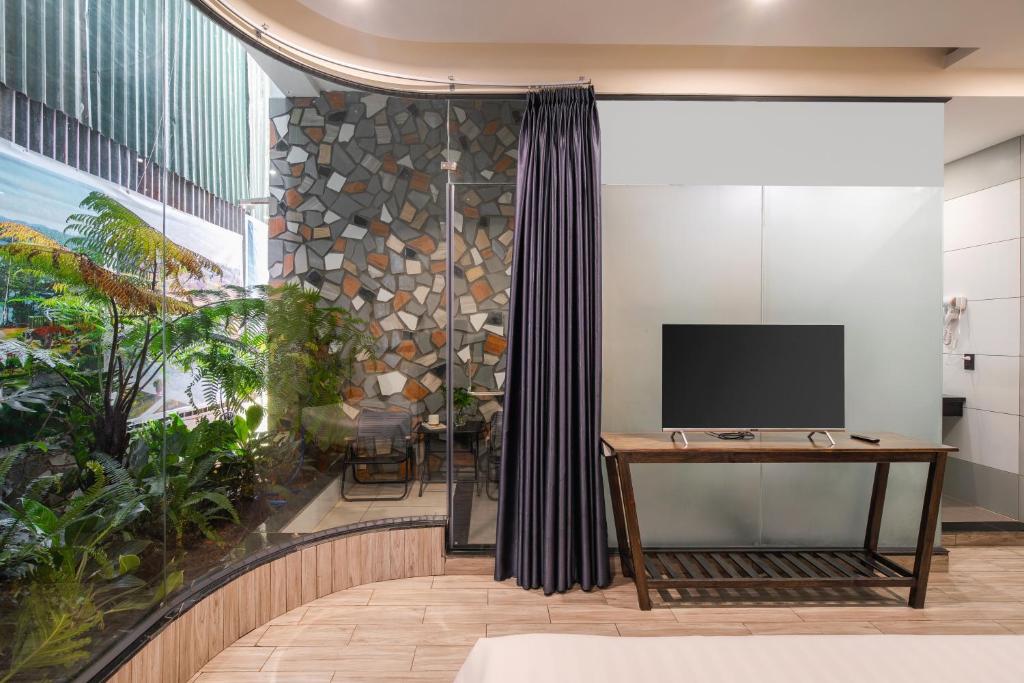 TV a/nebo společenská místnost v ubytování Greenview City Hotel