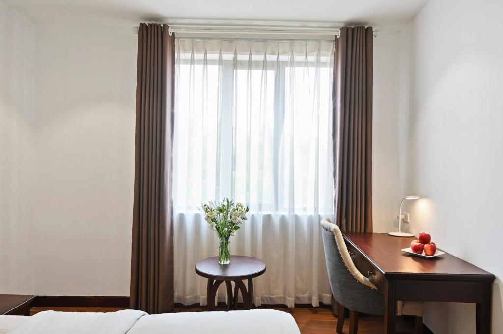 Postel nebo postele na pokoji v ubytování 22Land Residence Hotel & Spa Hanoi