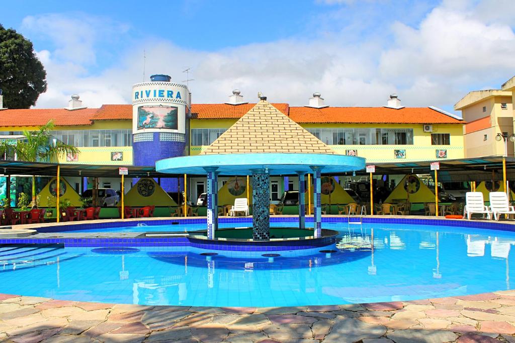 a large swimming pool in front of a hotel at Hotel Riviera D Amazonia Belem Ananindeua in Belém