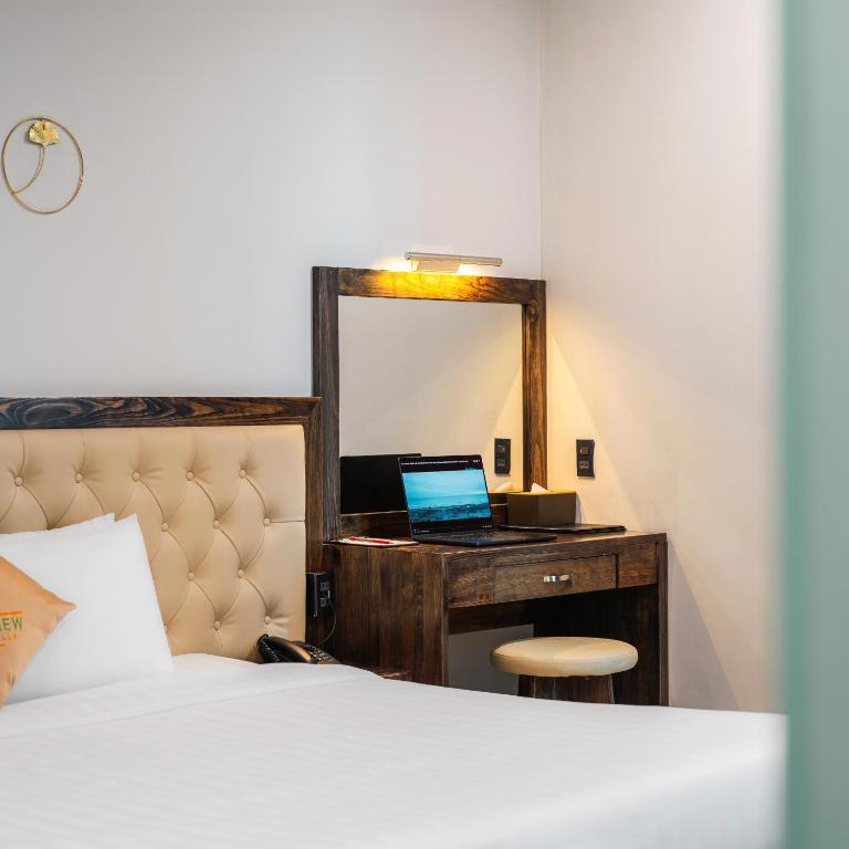 Postel nebo postele na pokoji v ubytování Greenview City Hotel