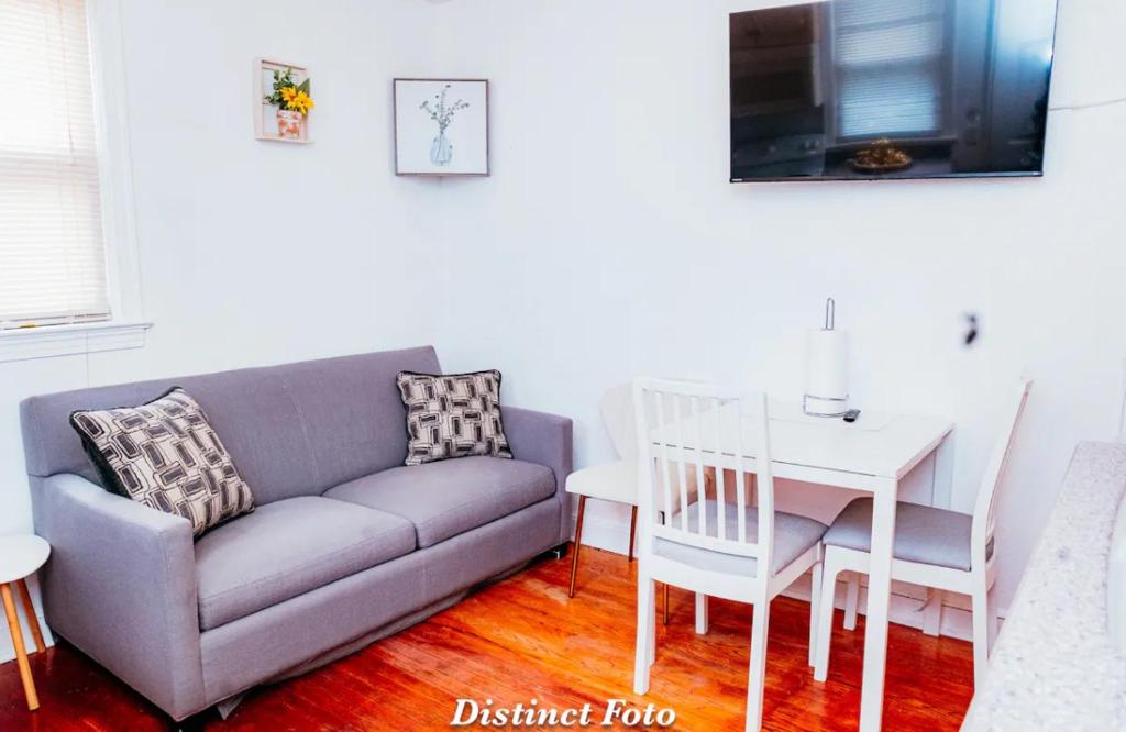 a living room with a couch and a table at DC 2BD and 1BA Condo w Parking 10 min walk to metro in Washington