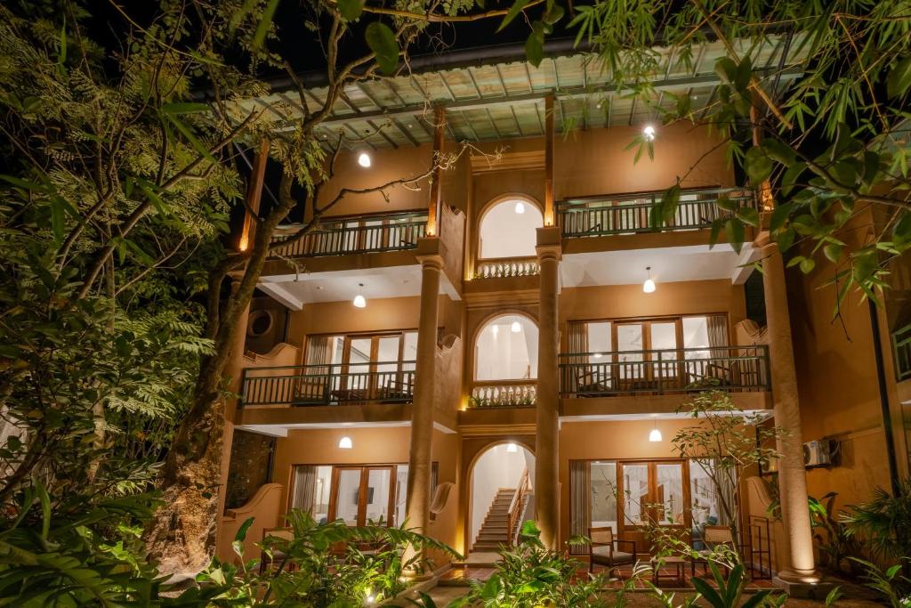 an exterior view of a building with trees at Aurora in Unawatuna