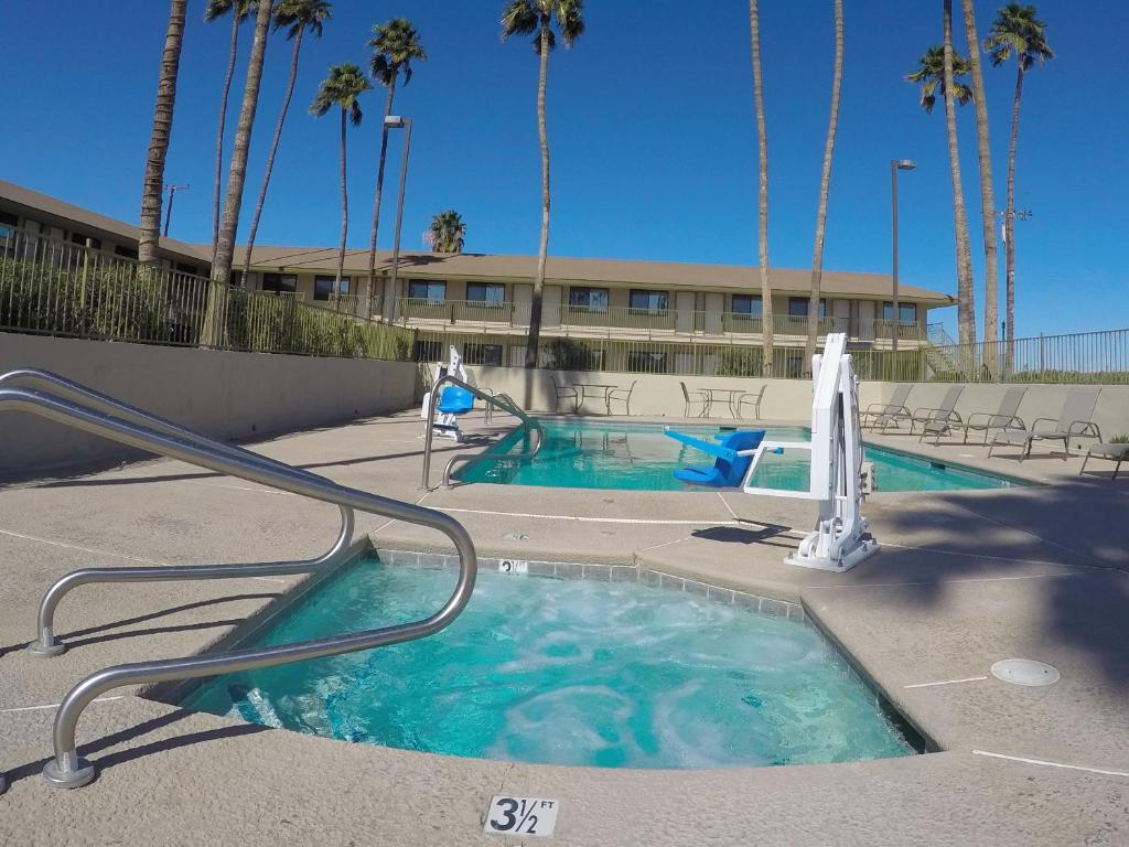a swimming pool with a slide in front of a building at Americas Best Value Inn Blythe CA in Blythe