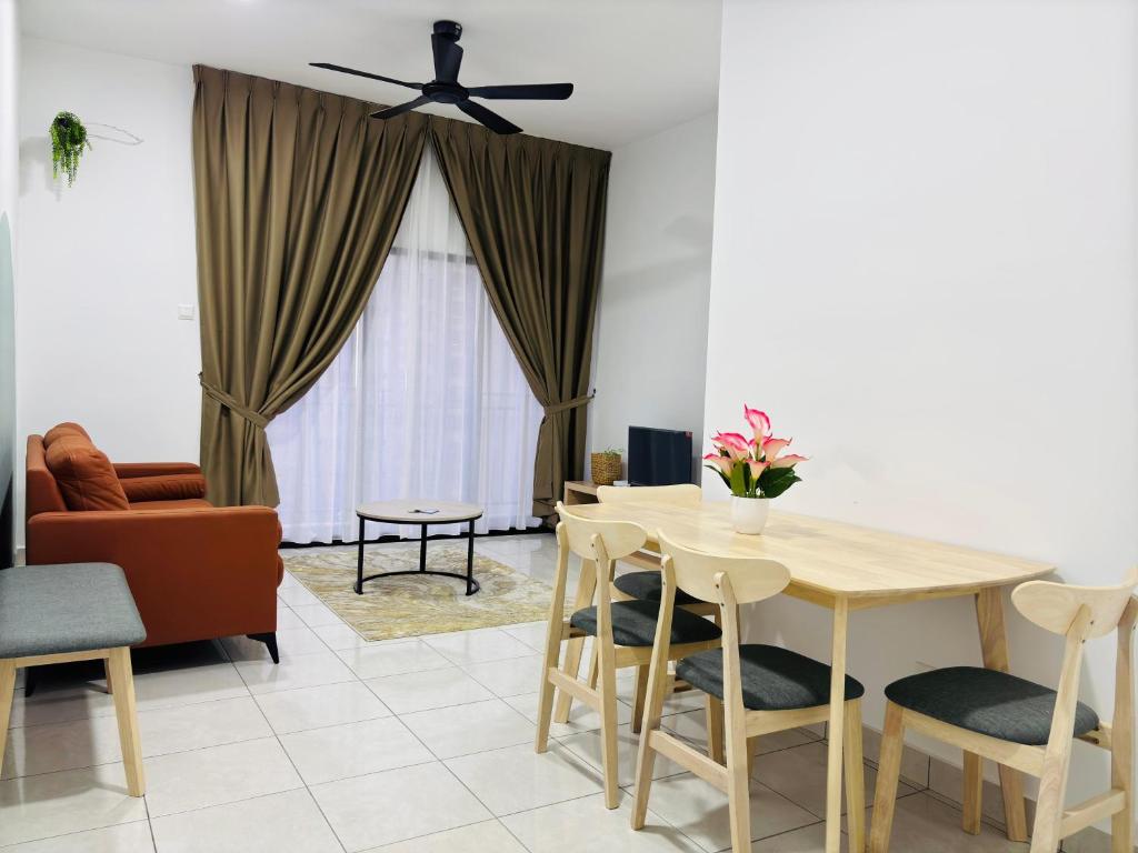 a living room with a table and a ceiling fan at Youth City Residence in Nilai
