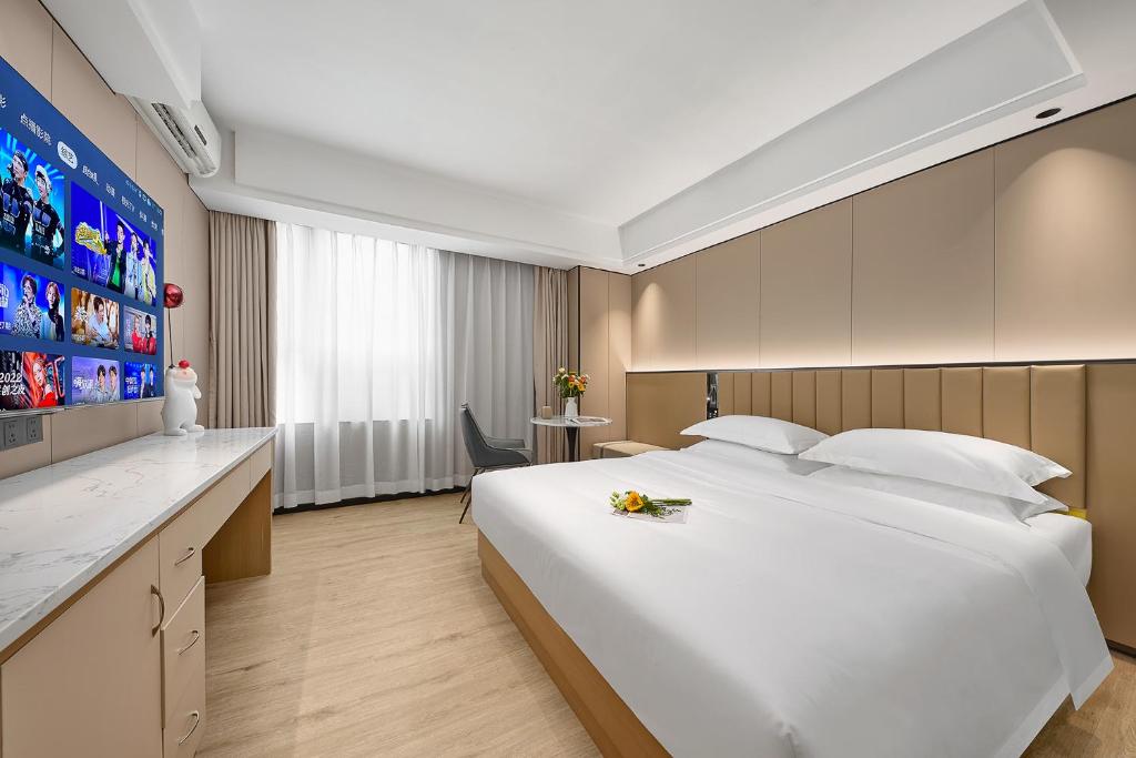 Postel nebo postele na pokoji v ubytování Meiye Hotel Zhujiang Newtown - Wuyangcun Metro - Canton Fair