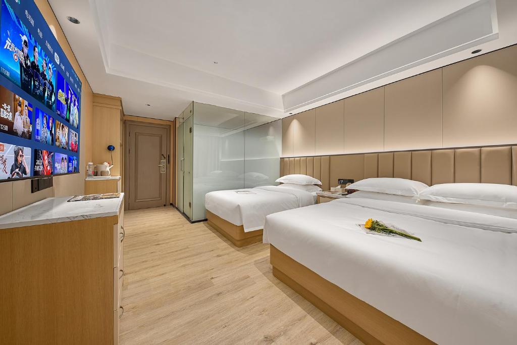 Postel nebo postele na pokoji v ubytování Meiye Hotel Zhujiang Newtown - Wuyangcun Metro - Canton Fair