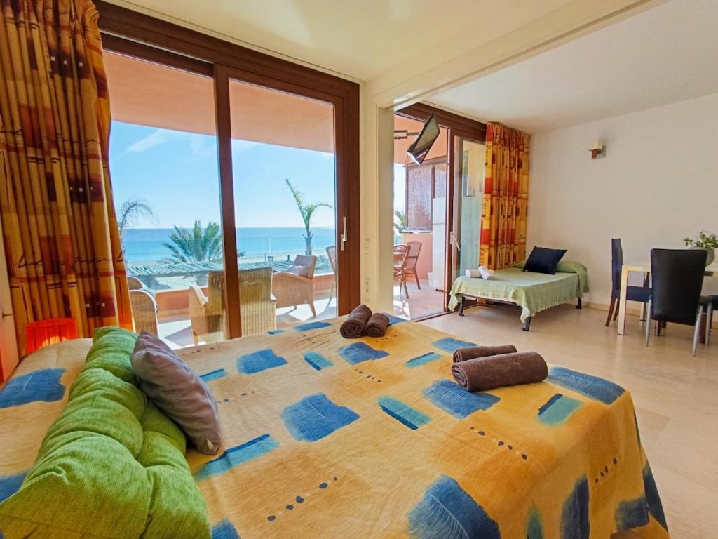 a bedroom with a large bed with a view of the ocean at Apart Ibiza Close to Hi & Ushuaia SEA FRONT in Illes Balears