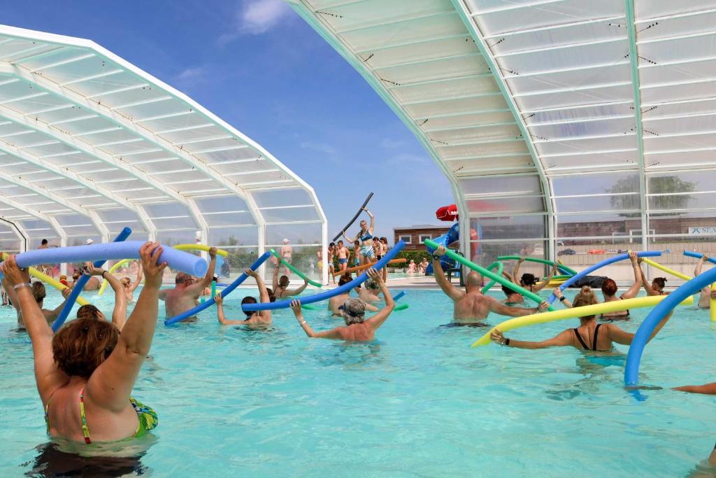 a group of people in the water at a water park at Camping Village Capalonga in Bibione