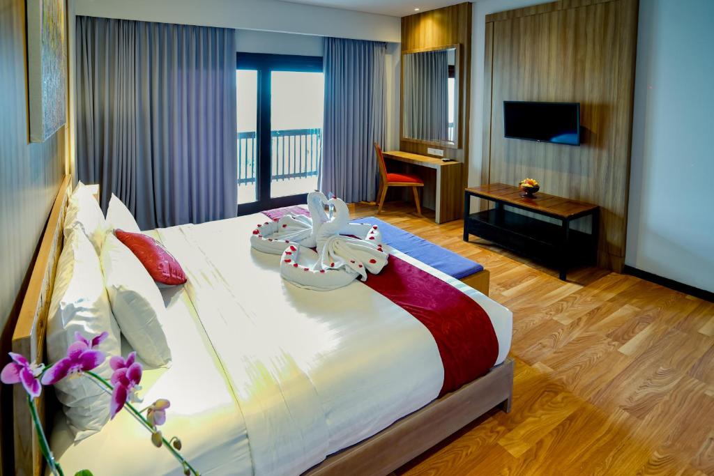 Postel nebo postele na pokoji v ubytování The Kirana Canggu Hotel