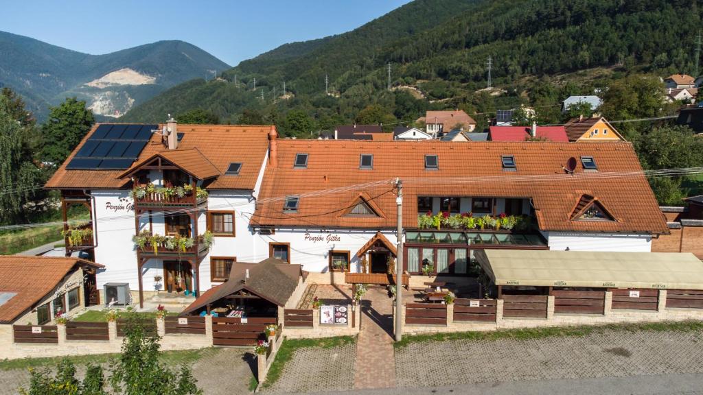 a large building with solar panels on its roof at Penzión Gitka in Vrútky