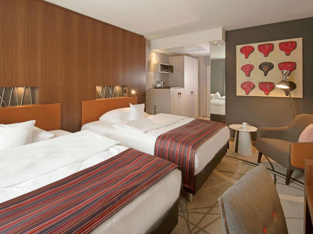 Postel nebo postele na pokoji v ubytování Mövenpick Hotel Münster am Aasee