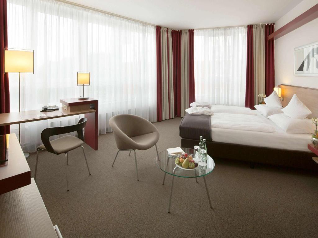 Postel nebo postele na pokoji v ubytování Mövenpick Hotel Münster am Aasee