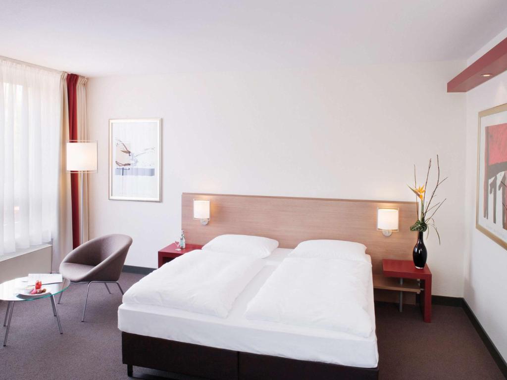 Postel nebo postele na pokoji v ubytování Mövenpick Hotel Münster am Aasee