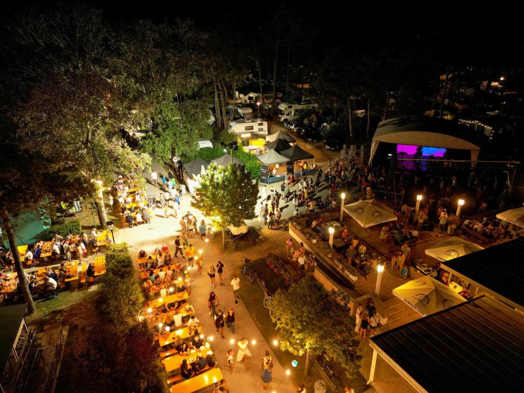 an overhead view of an outdoor market at night at Camping Lido in Bibione