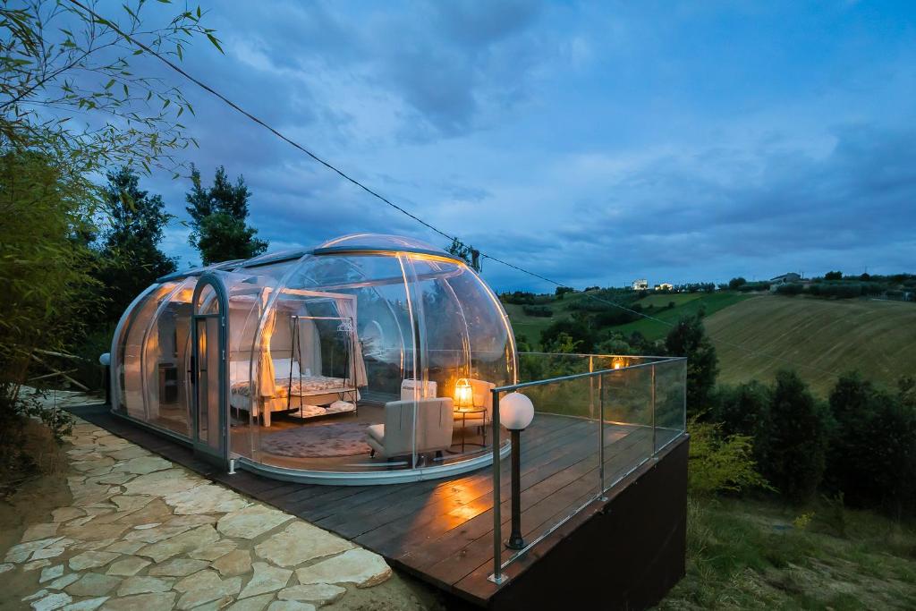 a dome house is sitting on a wooden deck at Bubble Perseus in Monsampolo del Tronto