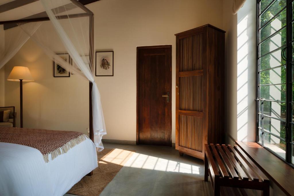 Postel nebo postele na pokoji v ubytování Neem Tree House