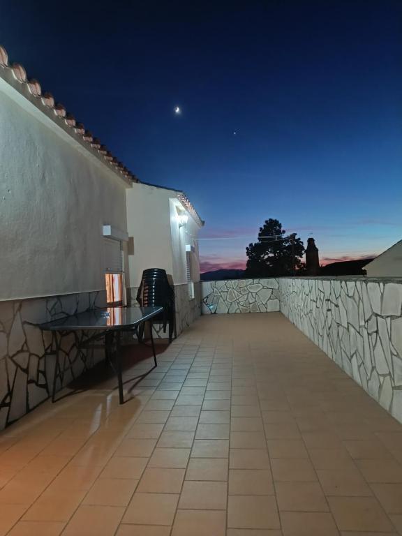 a bench sitting on the roof of a house at night at ÁTICO CAHI in El Bosque