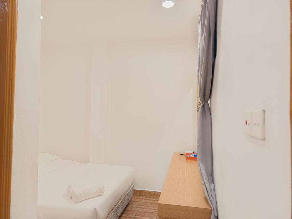 Postel nebo postele na pokoji v ubytování Shoreline Guesthouse 海岸线客栈