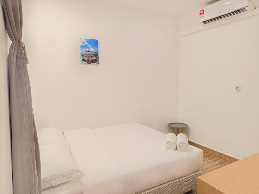 Postel nebo postele na pokoji v ubytování Shoreline Guesthouse 海岸线客栈