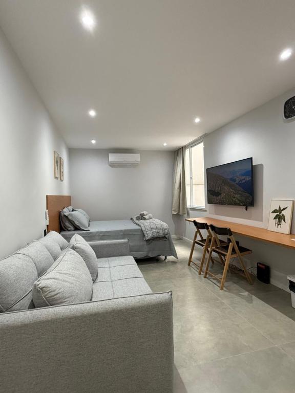 a living room with a couch and a table at Juca Studio Botafogo in Rio de Janeiro