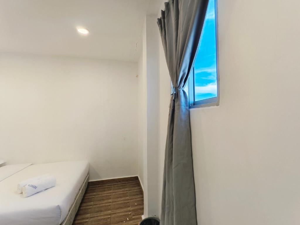 Postel nebo postele na pokoji v ubytování Shoreline Guesthouse 海岸线客栈