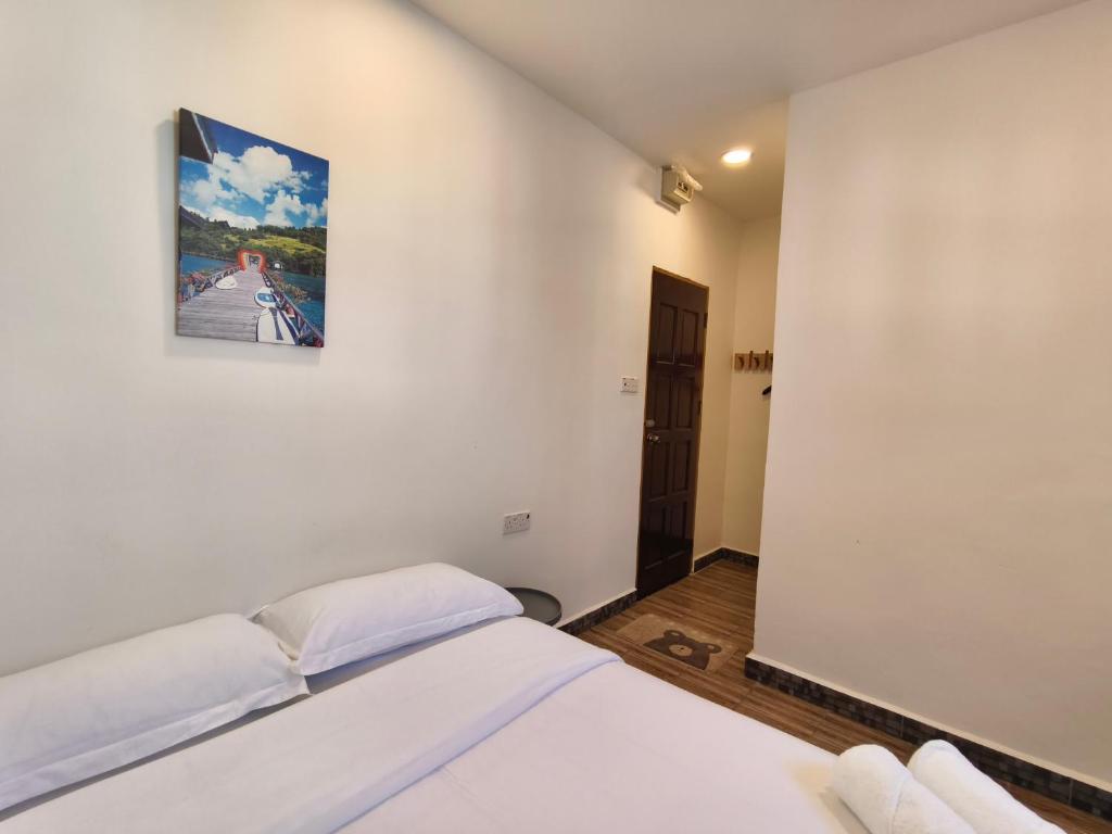 Postel nebo postele na pokoji v ubytování Shoreline Guesthouse 海岸线客栈