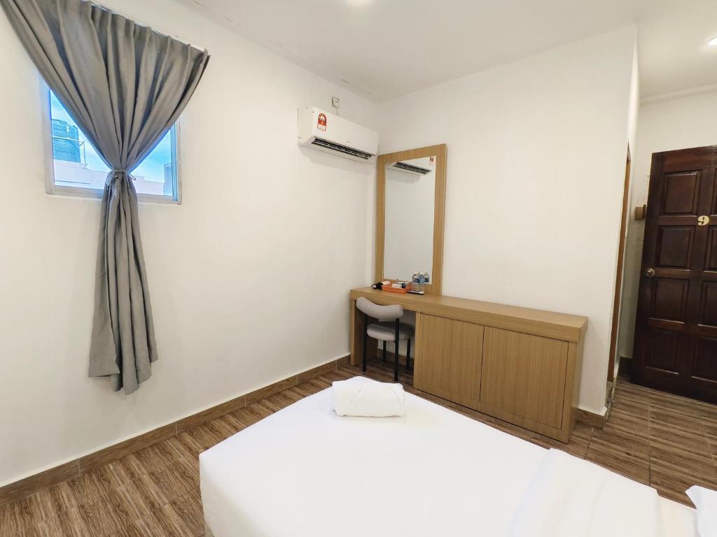 Postel nebo postele na pokoji v ubytování Shoreline Guesthouse 海岸线客栈