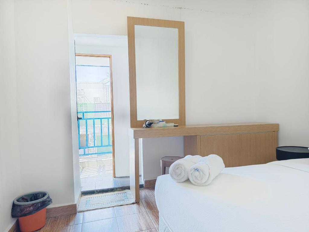 Postel nebo postele na pokoji v ubytování Shoreline Guesthouse 海岸线客栈
