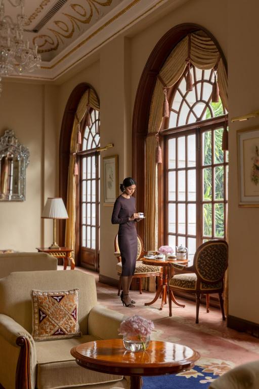 a pregnant woman standing in a room with windows at ITC Windsor, a Luxury Collection Hotel, Bengaluru in Bengaluru