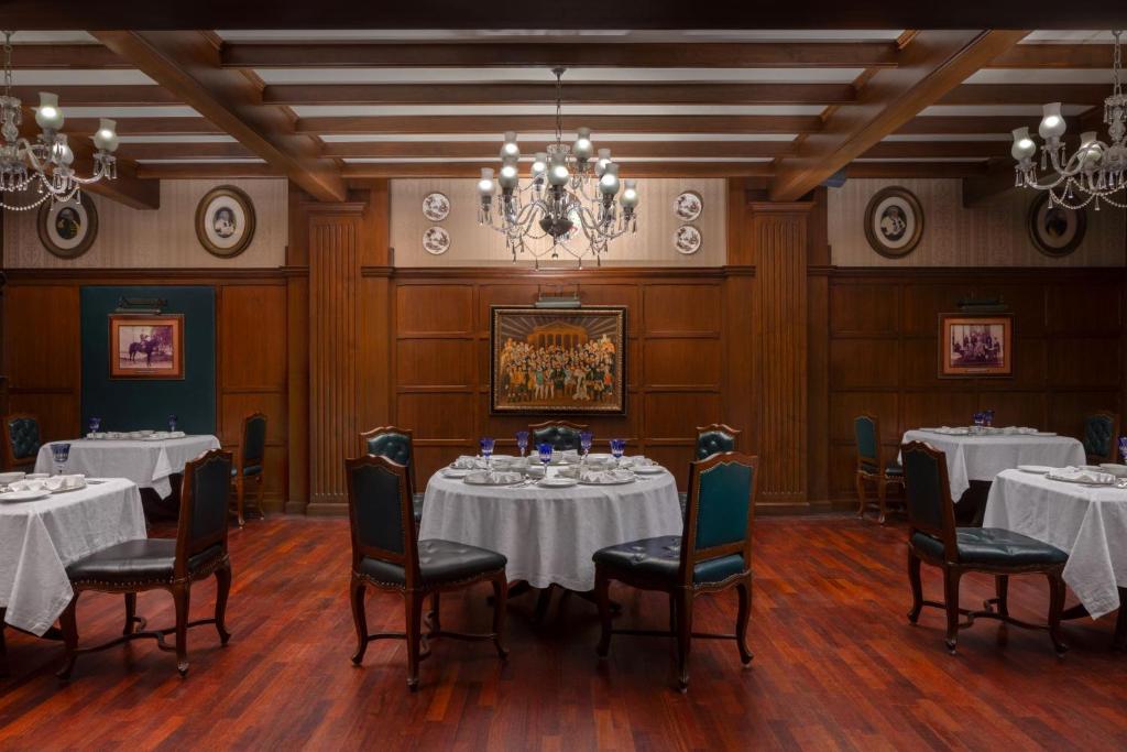 a conference room with tables and chairs and a chandelier at ITC Windsor, a Luxury Collection Hotel, Bengaluru in Bengaluru