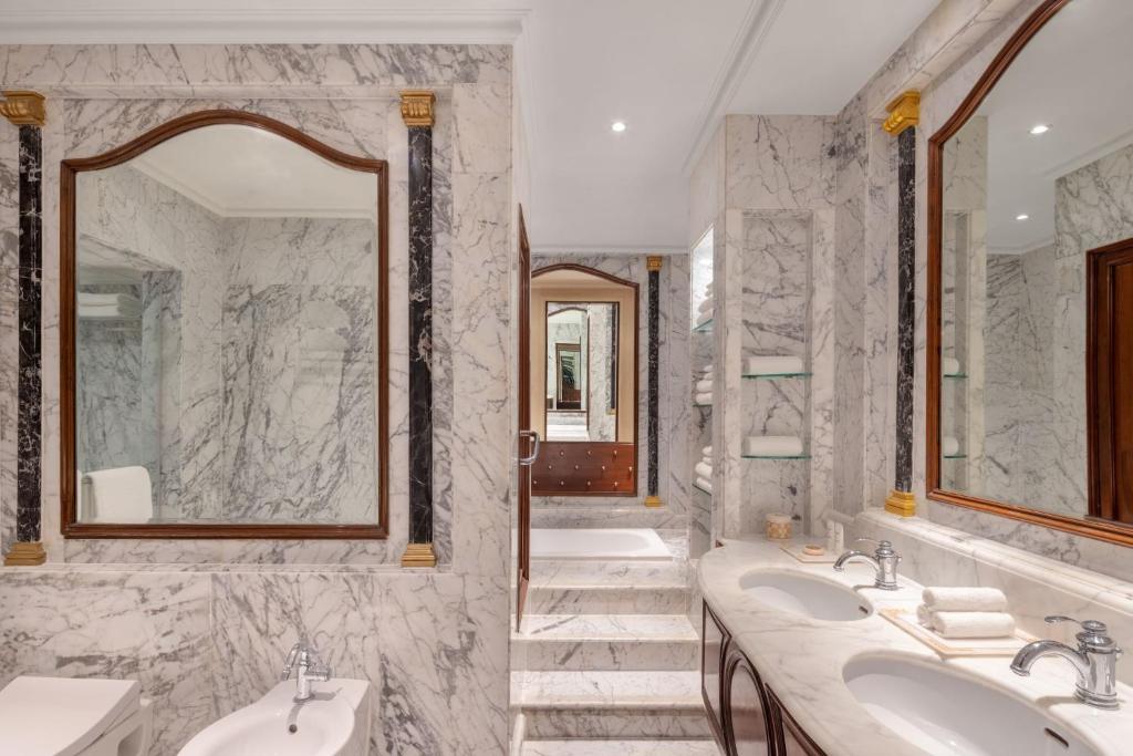 a bathroom with two sinks and two mirrors at ITC Windsor, a Luxury Collection Hotel, Bengaluru in Bengaluru