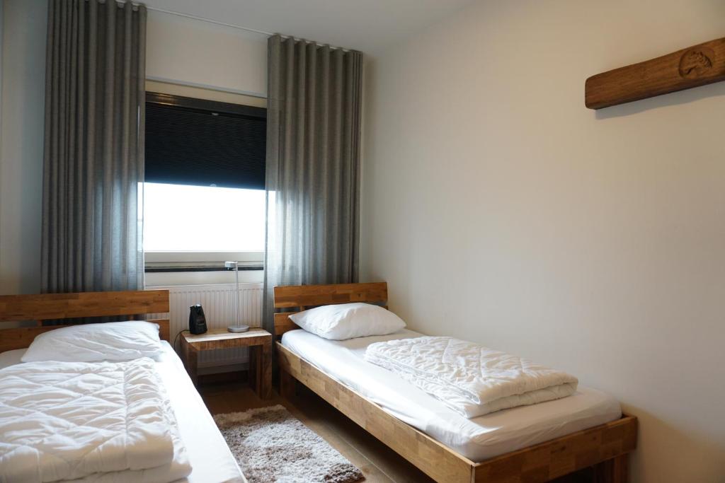 En eller flere senge i et værelse på Kustverhuur, Appartement aan Zee, Port Scaldis 01061