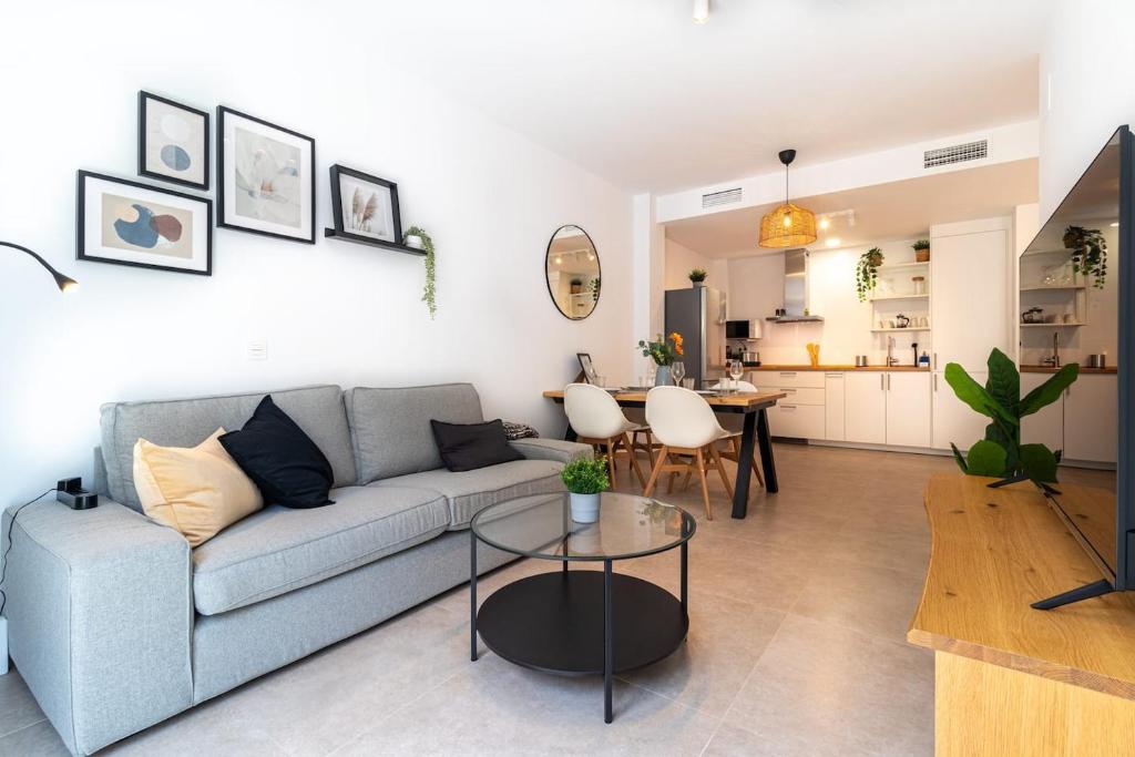 a living room with a couch and a table at Charming Apartment in the Heart of Málaga in Málaga