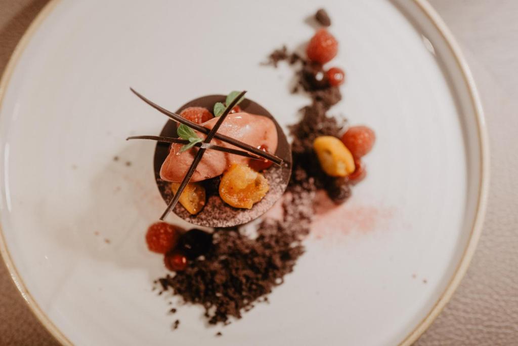 a dessert on a white plate on a table at Hotel Berghof - St Johann in Salzburg in Sankt Johann im Pongau