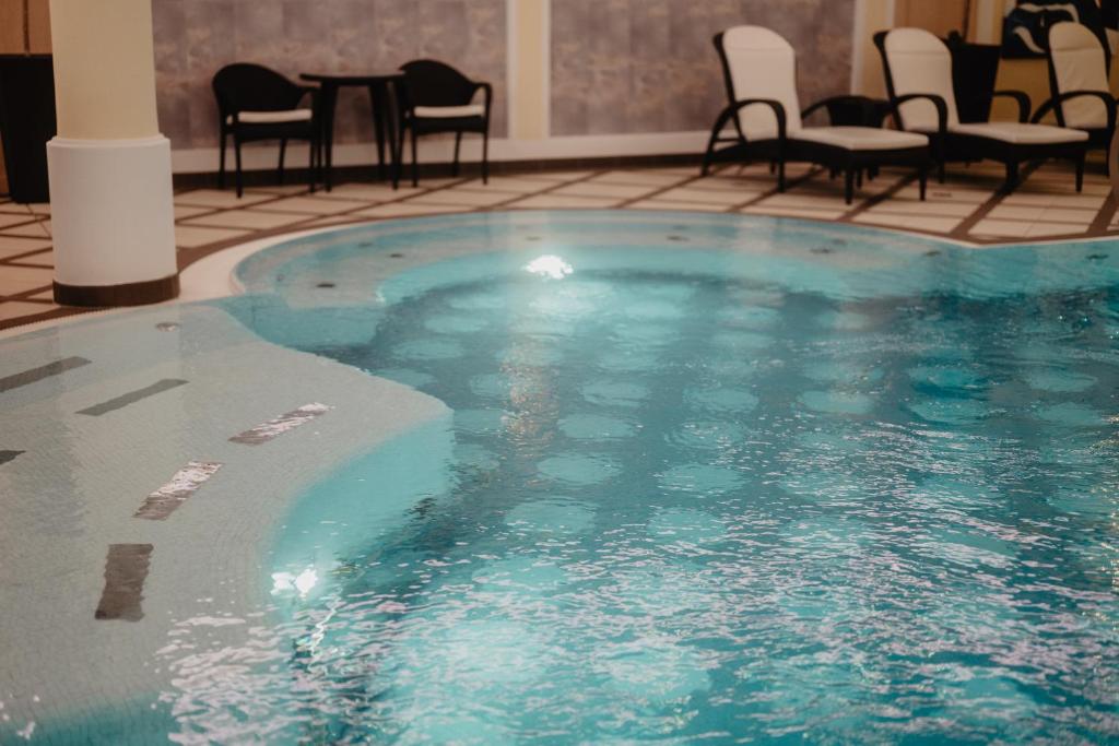 a large swimming pool in a hotel room at Hotel Berghof - St Johann in Salzburg in Sankt Johann im Pongau