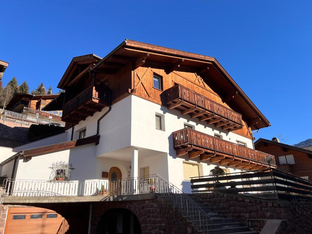 a building with wooden balconies on the side of it at Scurcia in Ortisei