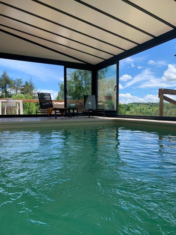une piscine avec vue sur l'eau dans l'établissement La Bergerie de Chantemille - Les Mésanges, à Ahun