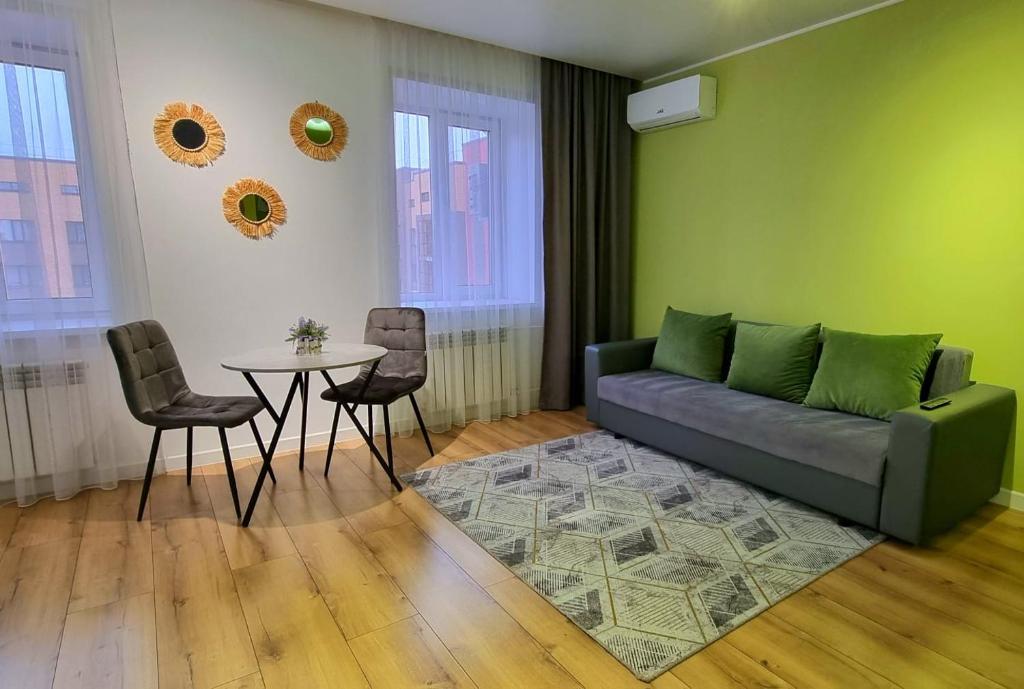 a living room with a couch and a table at Jenis in Kokshetau